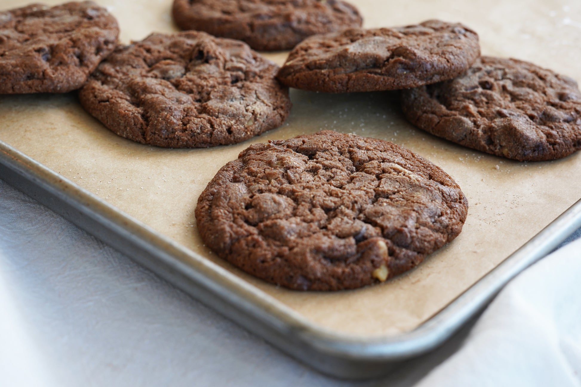 Polly's Pies Double Chocolate cookies on a baking sheet lined with parchment paper.