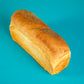 A loaf of Polly's Pies white bread on a blue background.